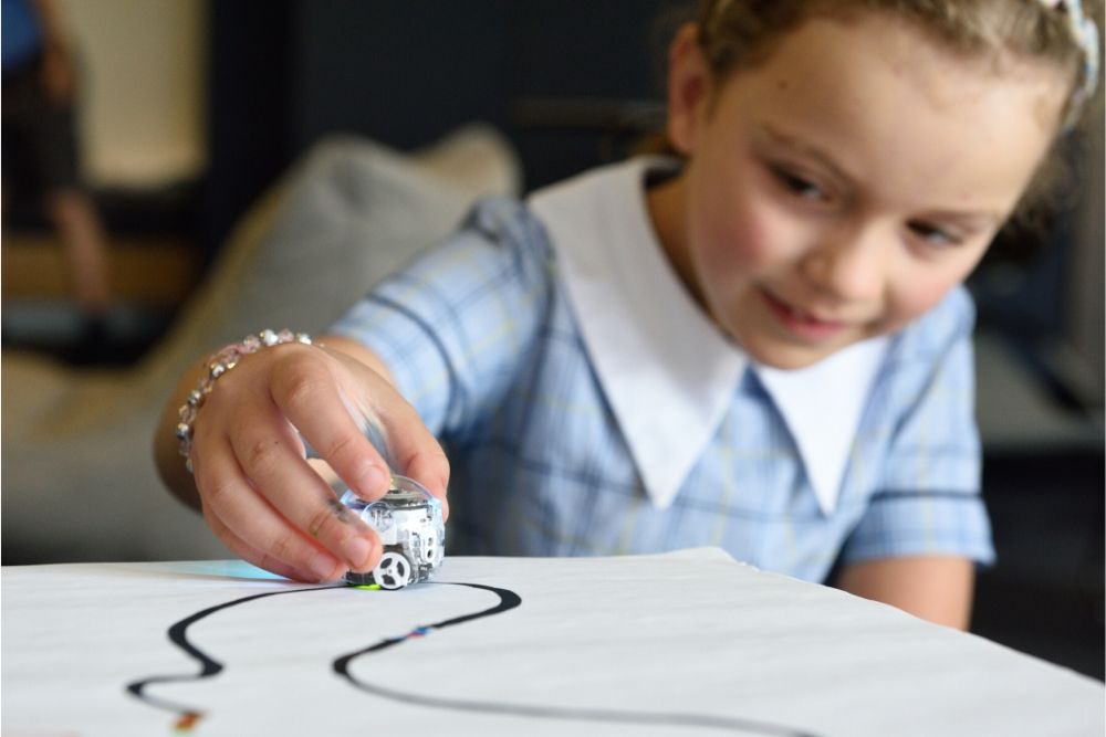 Menina criança brincando e mostrando a importância do inglês dentro da sala de aula.